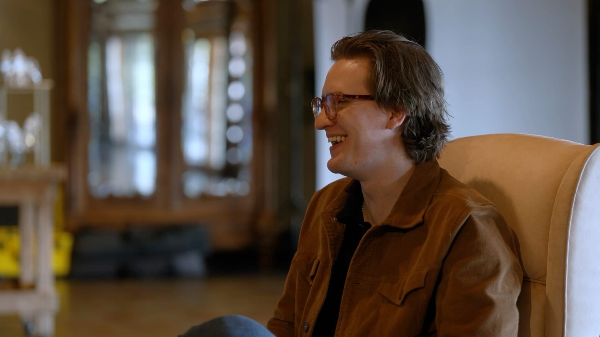A team member laughing in an armchair