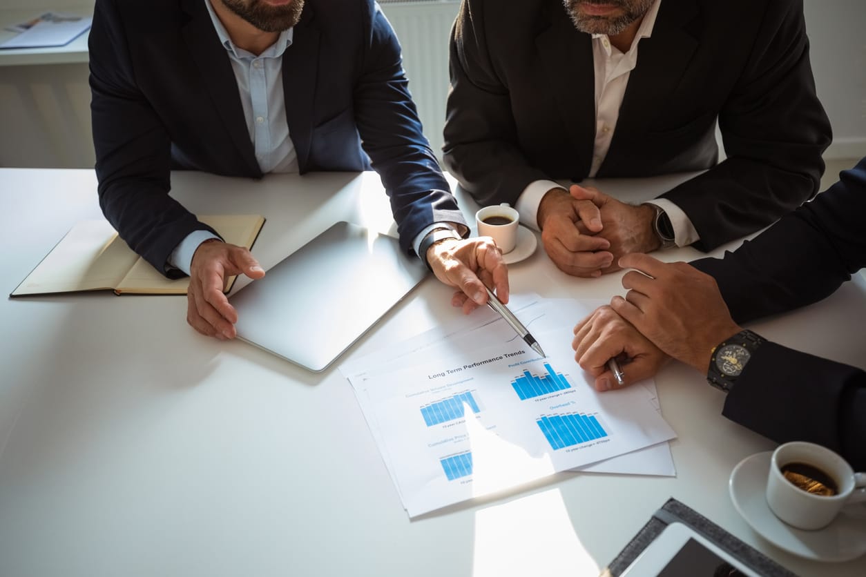Consultants reviewing a printed chart together at a table