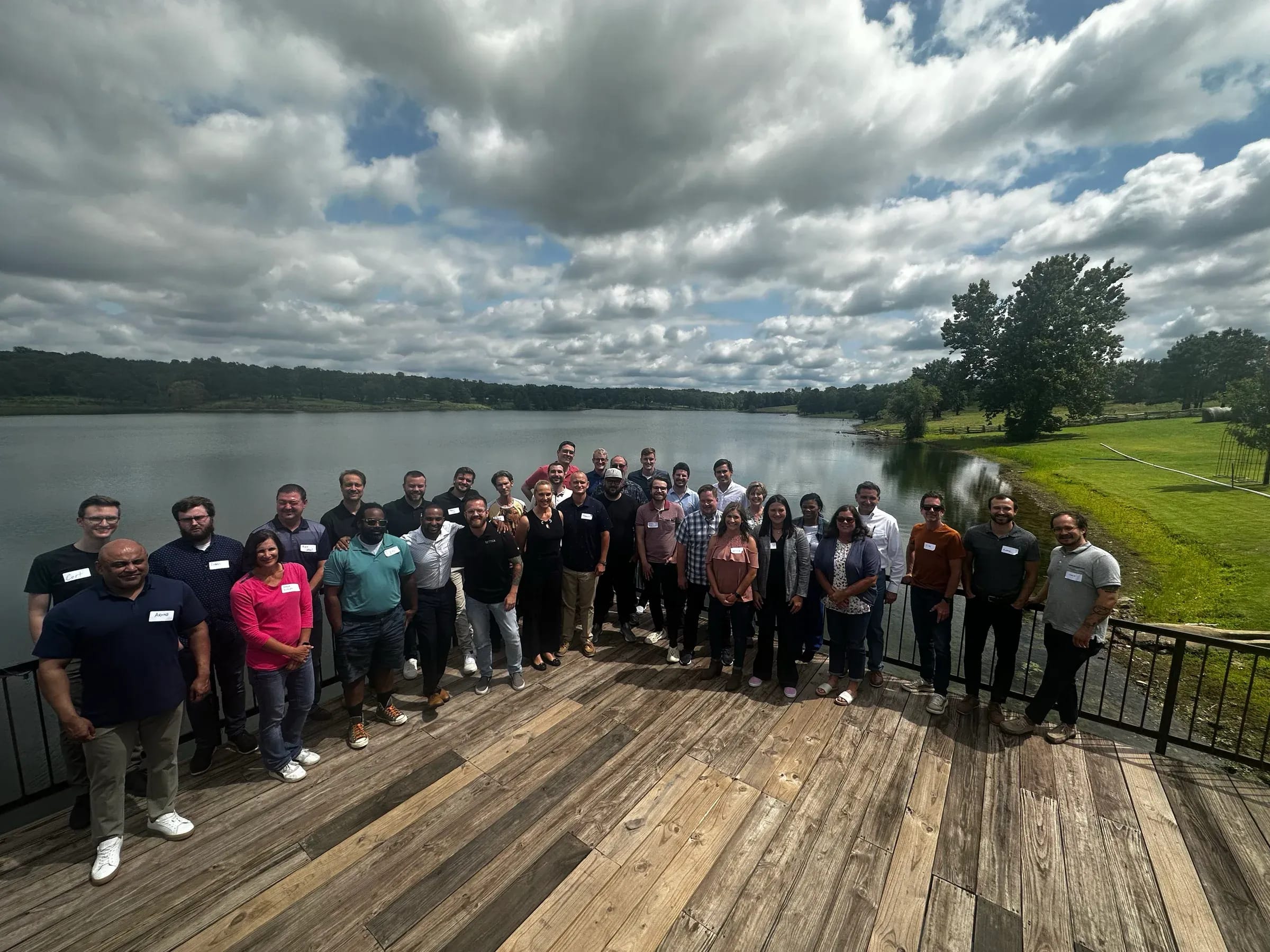 The full SEQTEK team on the deck at the annual meeting, overlooking the lake